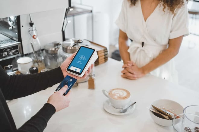 customer paying for coffee with business credit card