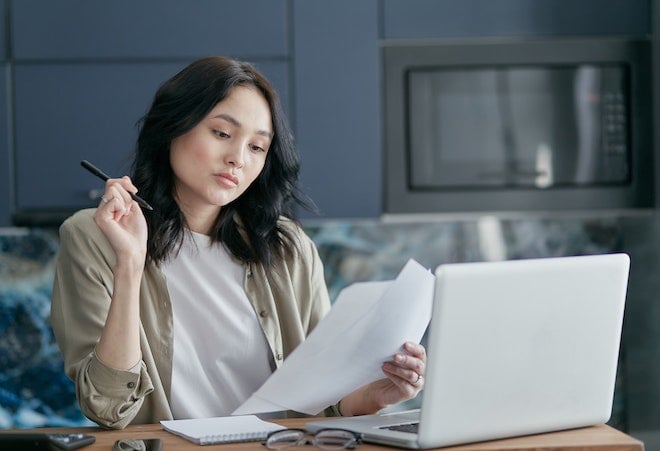 woman looking at tax paperwork